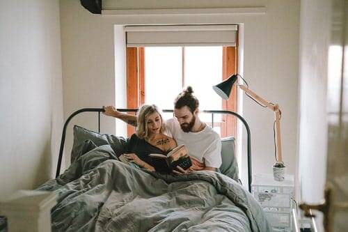 Couple in bed reading